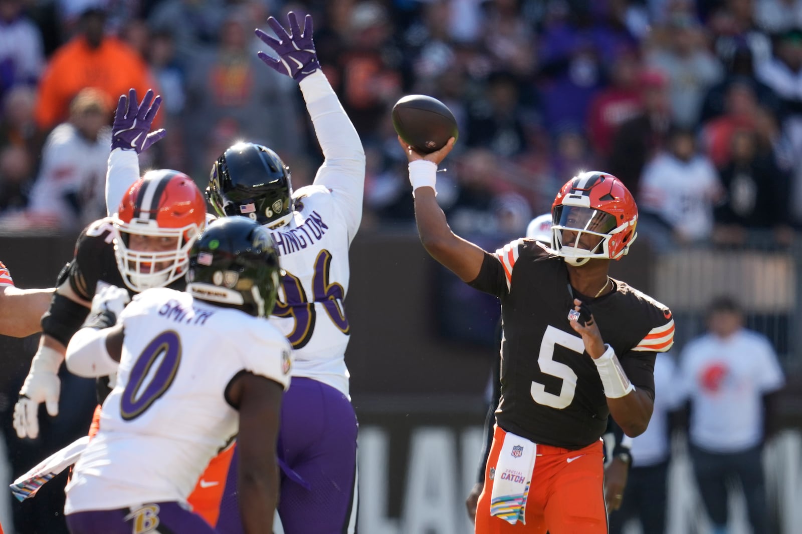 Cleveland Browns quarterback Jameis Winston (5) throws over Baltimore Ravens defensive tackle Broderick Washington (96) during the first half of an NFL football game in Cleveland, Sunday, Oct. 27, 2024. (AP Photo/Sue Ogrocki)