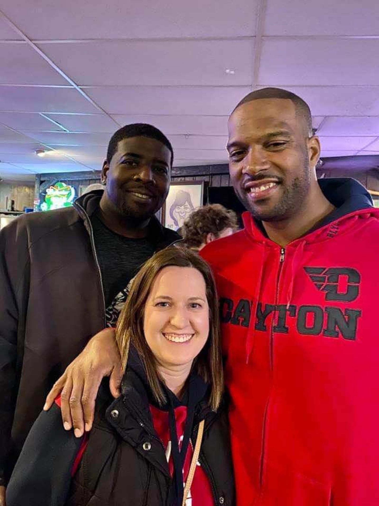 Coby Turner, right, with Amy Kraft, who was Oliver Purnell's secretary, and former teammate Nate Green, at UD Arena in February 2020.