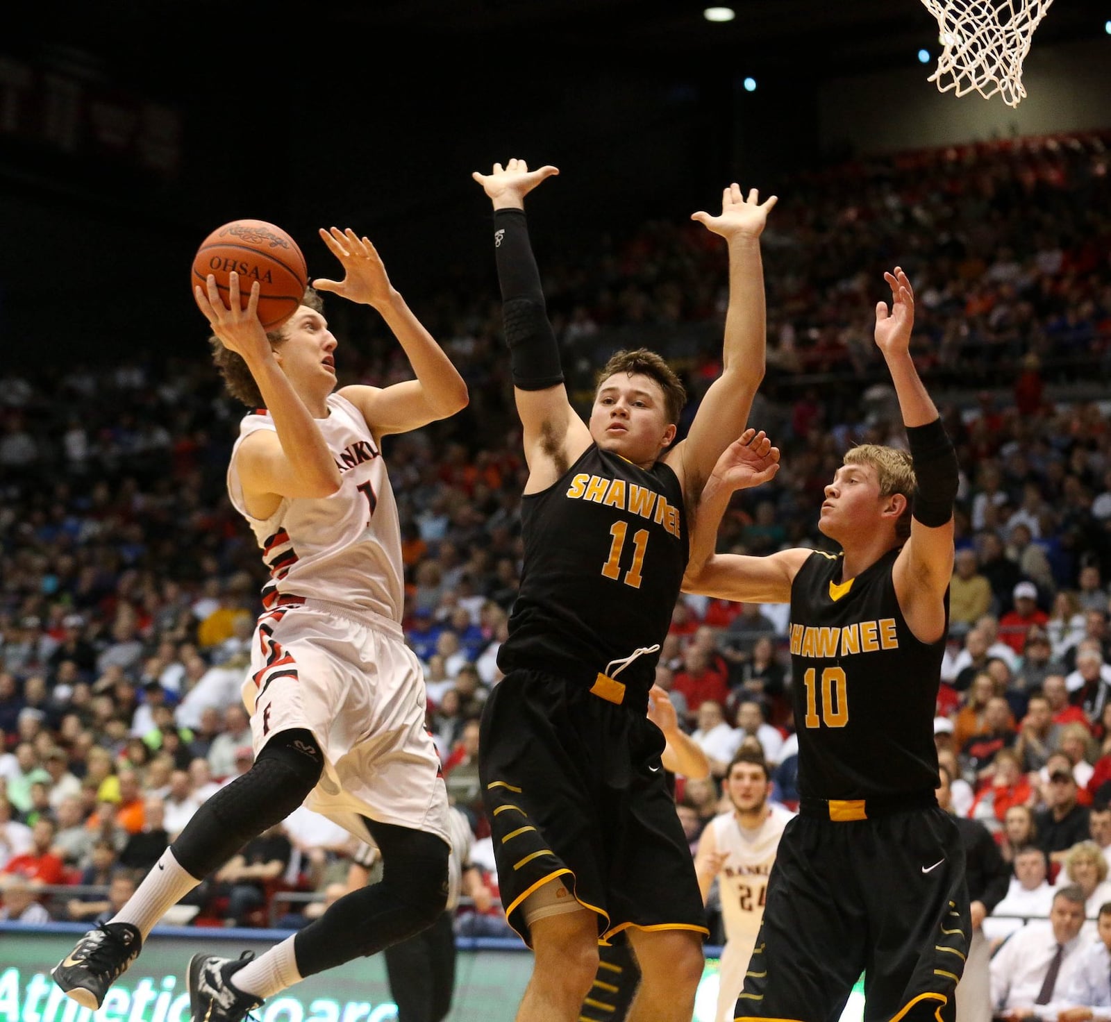 Franklin’s Austin Doliboa drives on Springfield Shawnee’s Seth Gray (11) and Andrew Tincher (10) during a Division II district final on March 13, 2015, at the University of Dayton Arena. JIM WITMER/STAFF