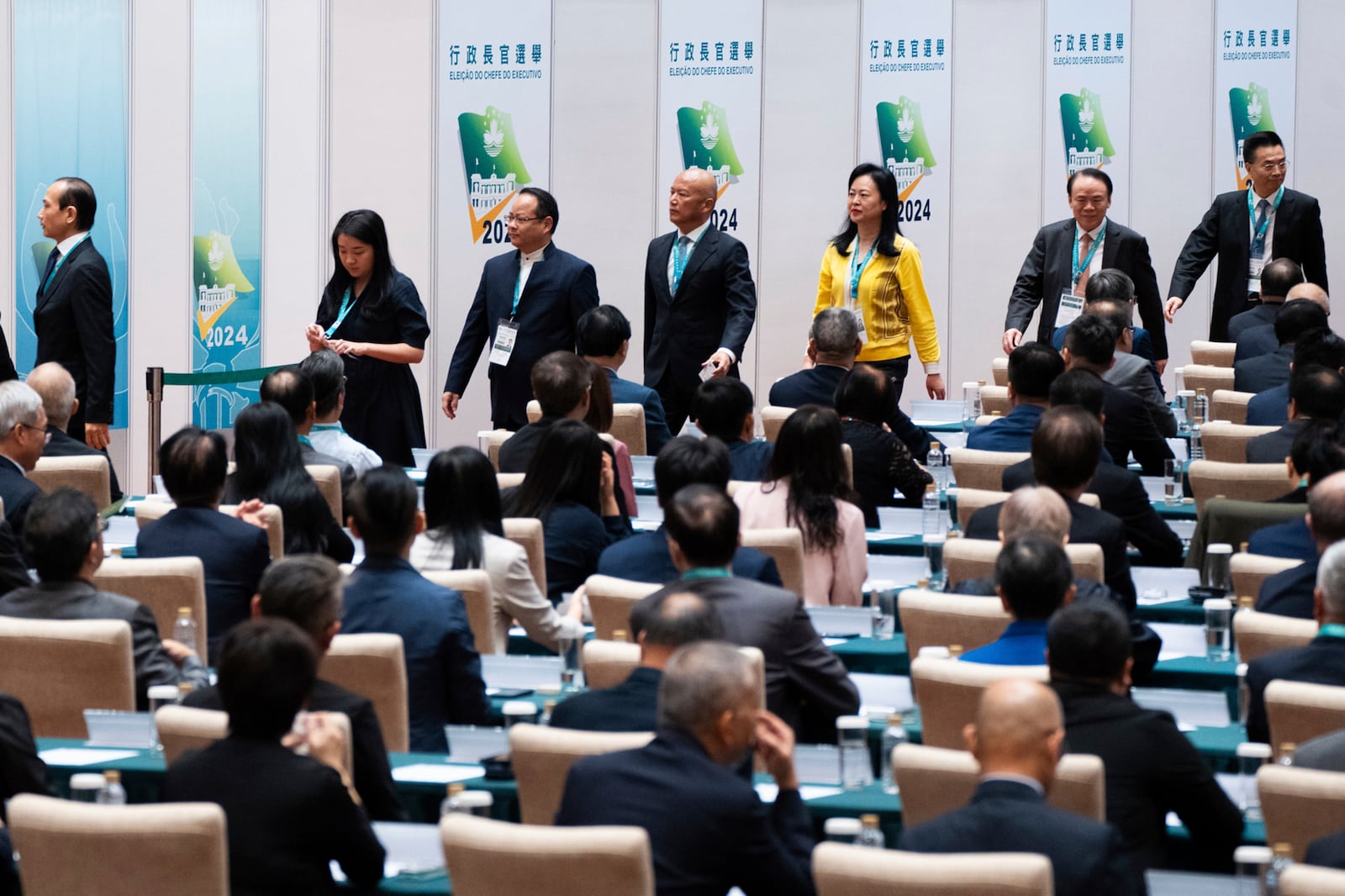 Election committee members queue to vote during the chief executive election, Sunday, October 13, 2024. (AP Photo/Bertha Wang)