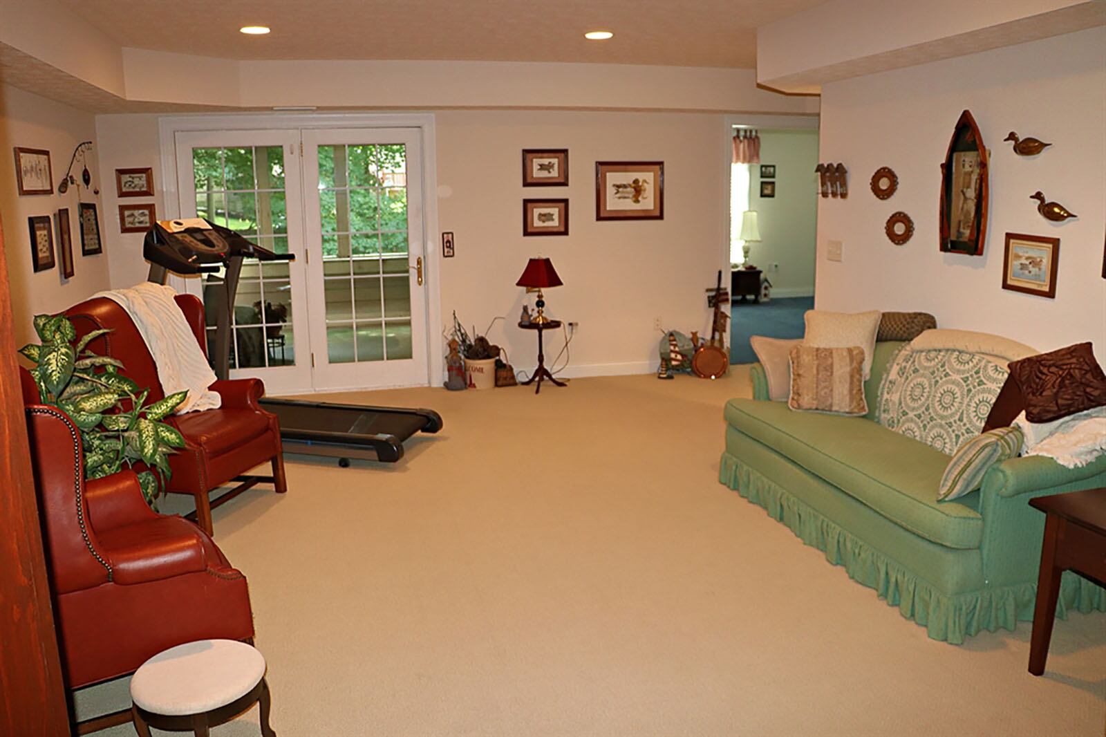 A spacious family room is just off the stairwell to the left and has triple patio doors that open out to a screen-enclosed porch deck with the same tree-lined creek. Double doors open from the family room into a multipurpose room that could be a media room, hobby area or bedroom. CONTRIBUTED PHOTO BY KATHY TYLER