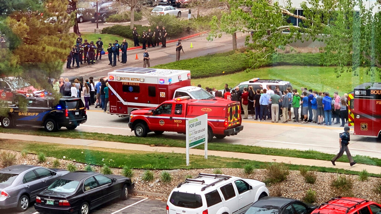 Police officers and students are seen outside STEM School Highlands Ranch, a charter middle school in the Denver suburb of Highlands Ranch, Colorado, after a shooting Tuesday, May 7, 2019.