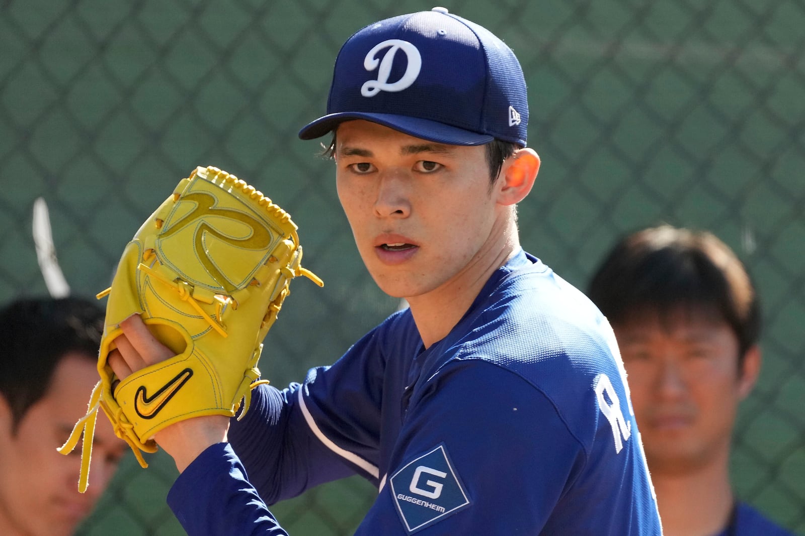 Los Angeles Dodgers pitcher Roki Sasaki (11) throws during his first live bullpen session during spring training baseball practice, Wednesday, Feb. 19, 2025, in Phoenix. (AP Photo/Darryl Webb)