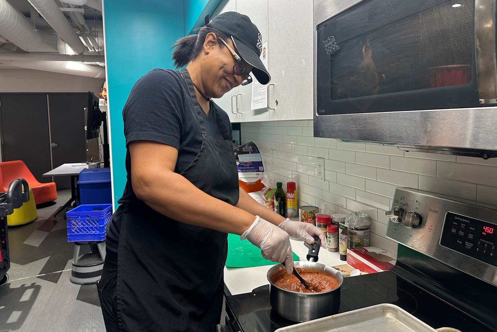 Chef Sharrie Agee prepares food as part of the Milwaukee Public Library’s Snack Hack program for kids on Nov. 19, 2024, Milwaukee. (AP Photo/Devi Shastri)