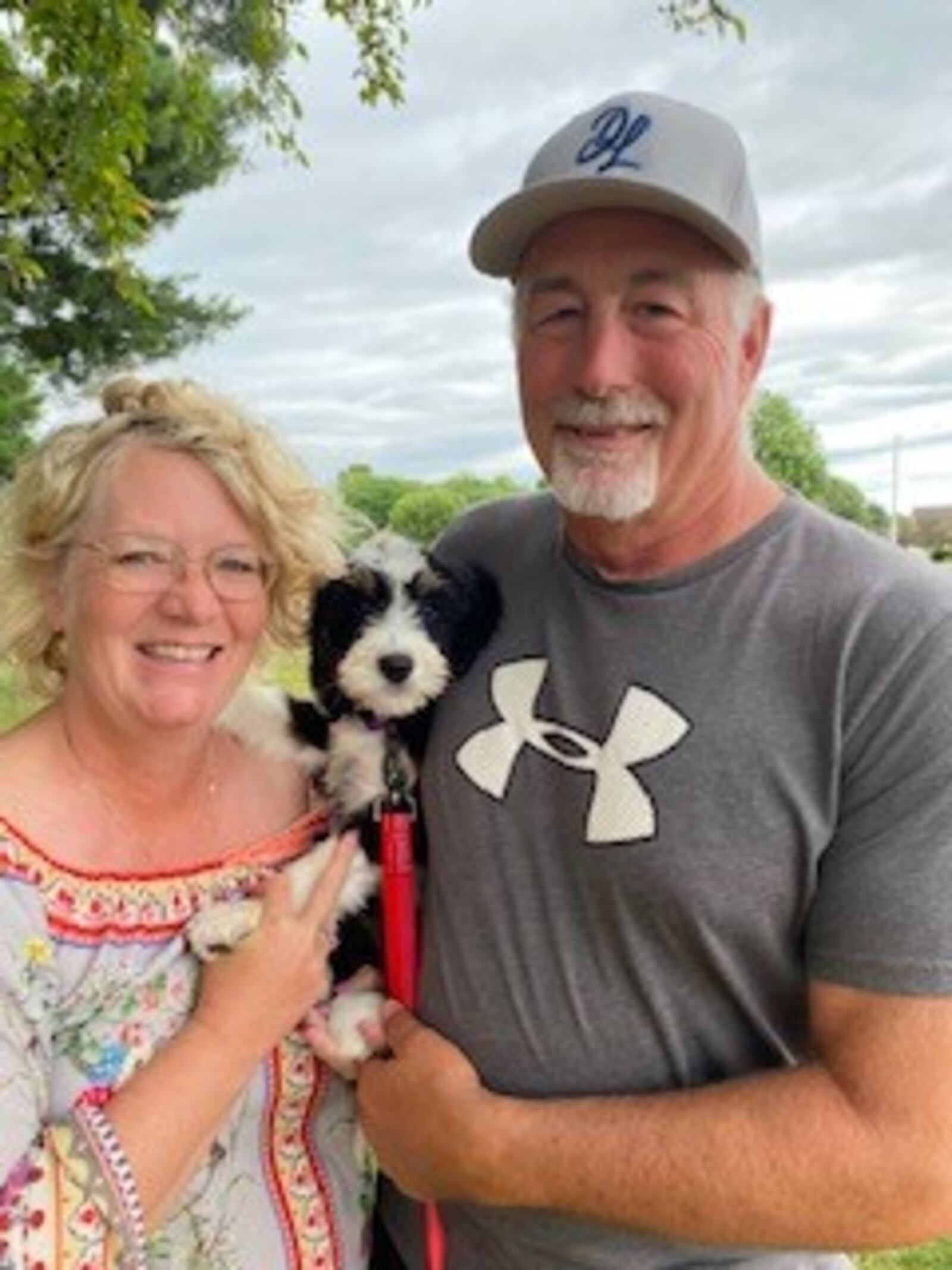 Donnie Deaton and his wife, Susan, with their new Bernedoodle puppy named Sugar Bear. CONTRIBUTED