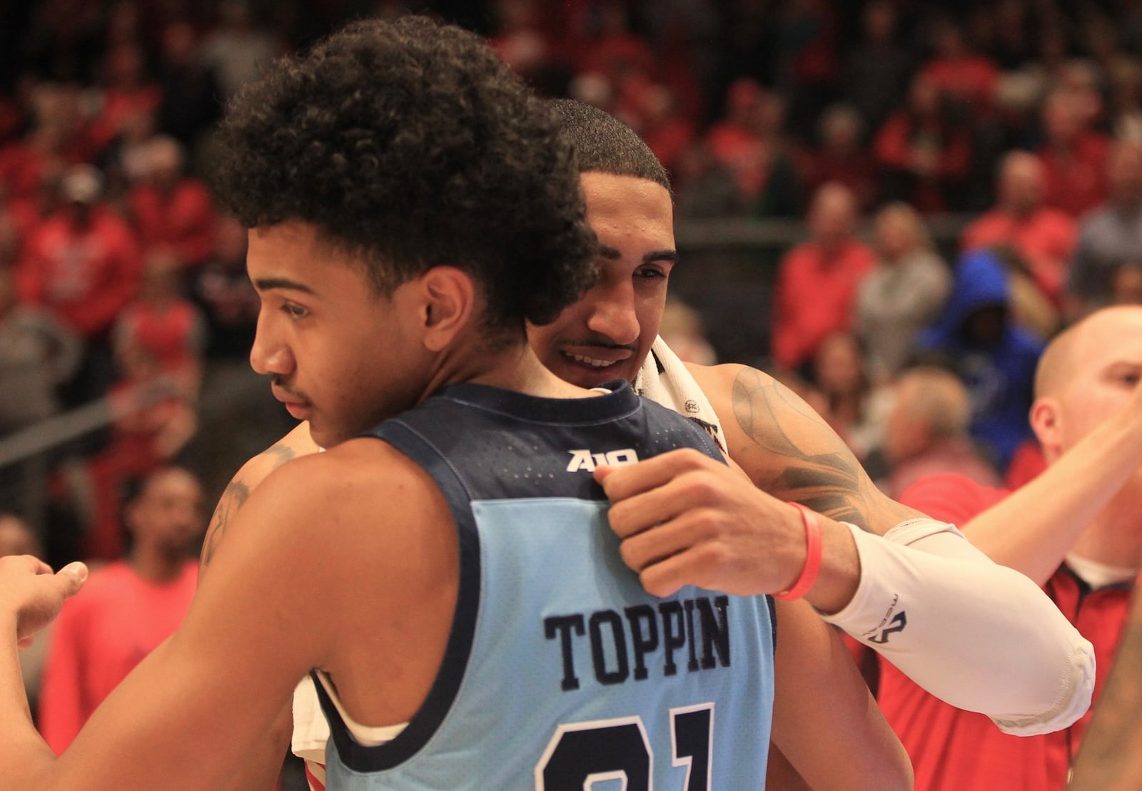 Dayton’s Obi Toppin hugs his younger brother Jacob after the game on Tuesday, Feb. 11, 2020, at UD Arena. David Jablonski/Staff