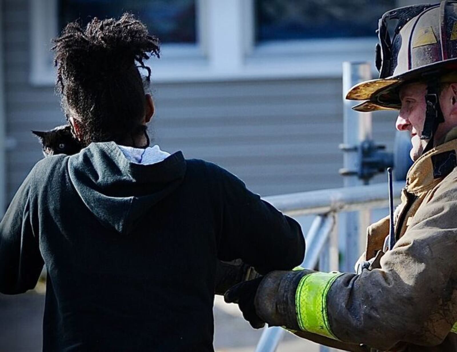 A resident is reunited with her cat, one of two rescued Monday morning, Nov. 15, from an apartment fire at the corner of Princeton Drive and Salem Avenue in Dayton. MARSHALL GORBY/STAFF