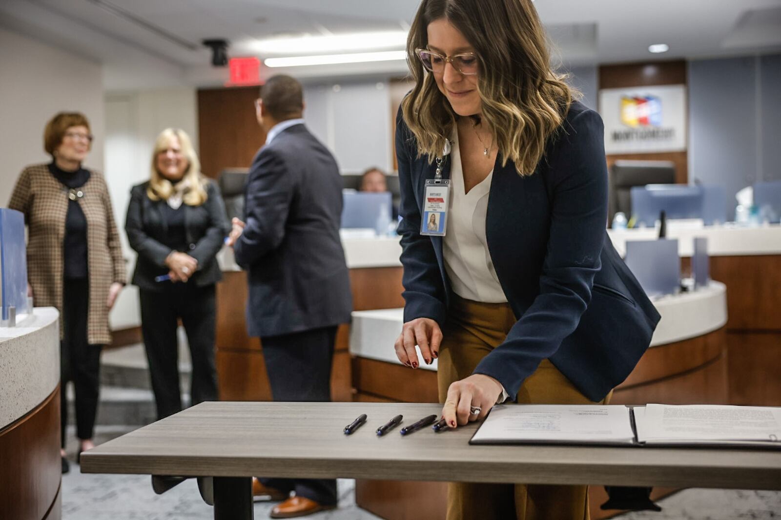 Montgomery County Director of Strategic Initiatives Haley Carretta signs an agreement with the Greater Dayton Area Hospitals and the Montgomery County Commissioners to address behavioral health needs in the Dayton area. The agreement was signed during at the Montgomery County Administration Building Tuesday January 10. 2023. JIM NOELKER/STAFF