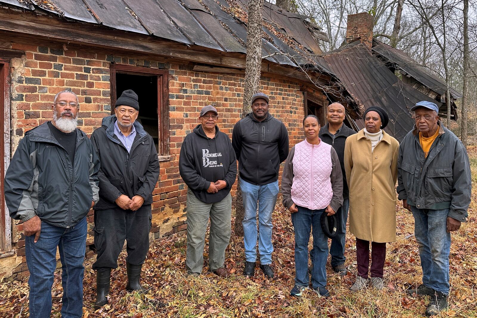 Descendants of Oak Hill sharecroppers stand outside the ruins of the property's once-grand plantation house near Danville, Va., Dec. 10, 2024. (AP Photo/Ben Finley)