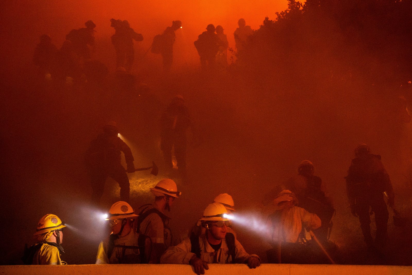 Firefighters battle the Franklin Fire in Malibu, Calif., on Tuesday, Dec. 10, 2024. (AP Photo/Ethan Swope)