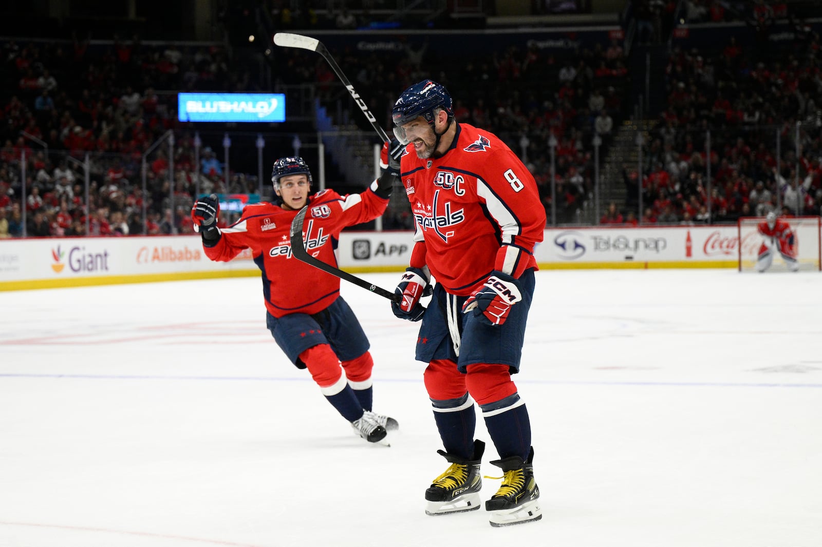 Washington Capitals left wing Alex Ovechkin (8) celebrates his goal with defenseman Martin Fehervary, back, during the first period of an NHL hockey game against the Columbus Blue Jackets, Saturday, Nov. 2, 2024, in Washington. (AP Photo/Nick Wass)