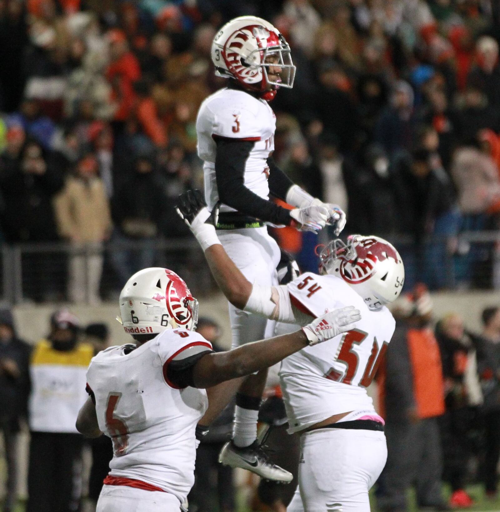 Sammy Anderson of Trotwood-Madison is hoisted after making the winning touchdown catch. Trotwood defeated Mansfield Senior 14-7 in overtime to win the Division III high school football championship at Tom Benson Hall of Fame Stadium in Canton on Friday. It was the Rams’ (12-3) third football state title, along with its 2011 and ‘17 championship teams. Anna also won a D-VI title on Friday and Marion Local will bid for the D-VII state title on Saturday. MARC PENDLETON / STAFF