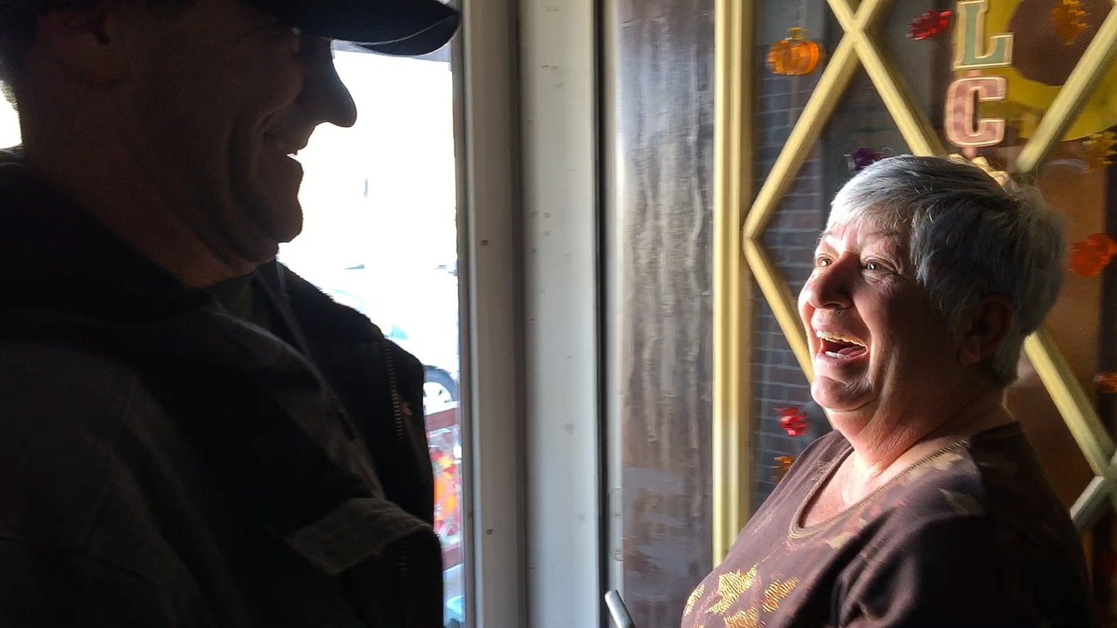 Matt Tepper, president of the Old North Dayton Neighborhood Association, informs Jeanine Wright that a new roof is going up on a tornado-damaged house across the street from her on Macready Avenue. CHRIS STEWART / STAFF