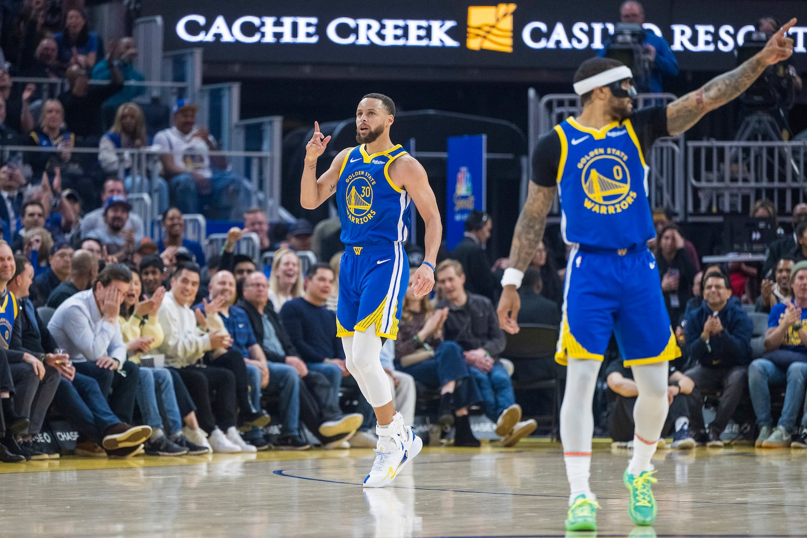 Golden State Warriors guard Stephen Curry (30) celebrates after scoring alongside guard Gary Payton II (0) during the first half of an NBA basketball game against the Portland Trail Blazers in San Francisco, Monday, March 10, 2025. (AP Photo/Nic Coury)