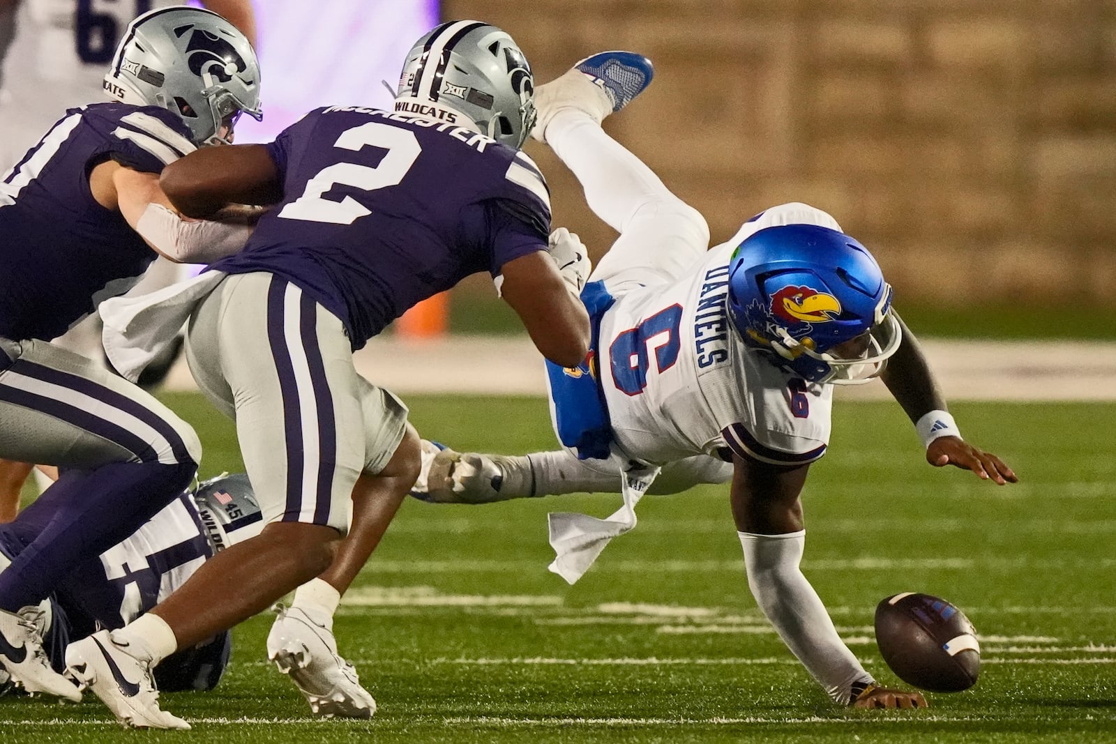 Kansas quarterback Jalon Daniels (6) fumbles the ball after being tackled by Kansas State linebacker Austin Romaine (45) during the second half of an NCAA college football game Saturday, Oct. 26, 2024, in Manhattan, Kan. Kansas State won 29-27. (AP Photo/Charlie Riedel)