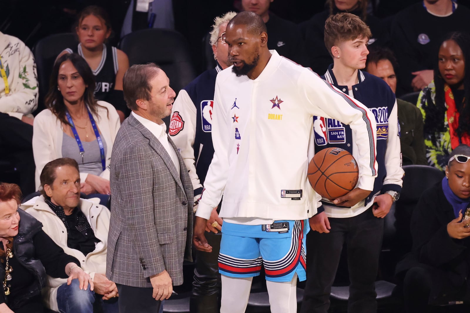 Golden State Warriors owner Joe Lacob, left, talks to Phoenix Suns forward Kevin Durant during the NBA All-Star basketball game Sunday, Feb. 16, 2025, in San Francisco. (AP Photo/Jed Jacobsohn)