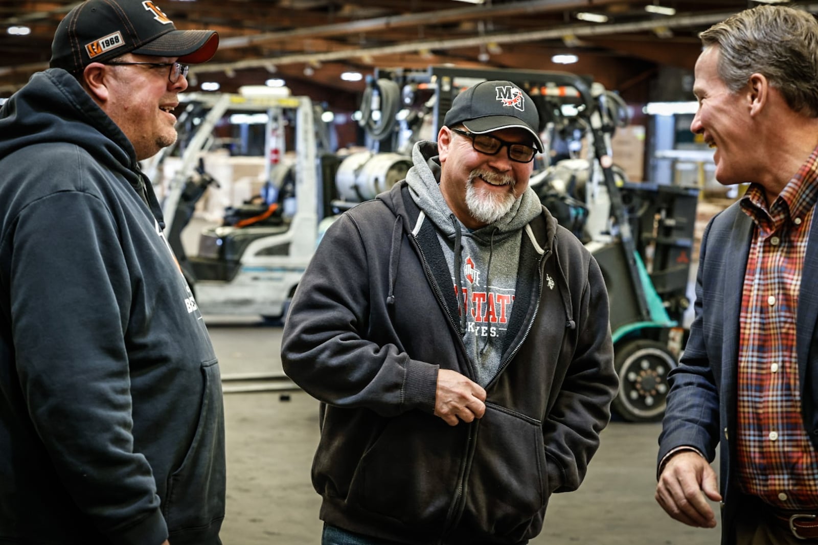 From left, David Allen and Kelly Davis, both dock workers at ABR Freightway joke around with Ohio Lt. Gov. Jon Husted at the company's terminal Tuesday October 10, 2023. Husted was at the freight way to announce new Ohio Bureau of Motor Vehicles modernizations, in including online renewal of Commercial Driver's License or CDLs. JIM NOELKER/STAFF