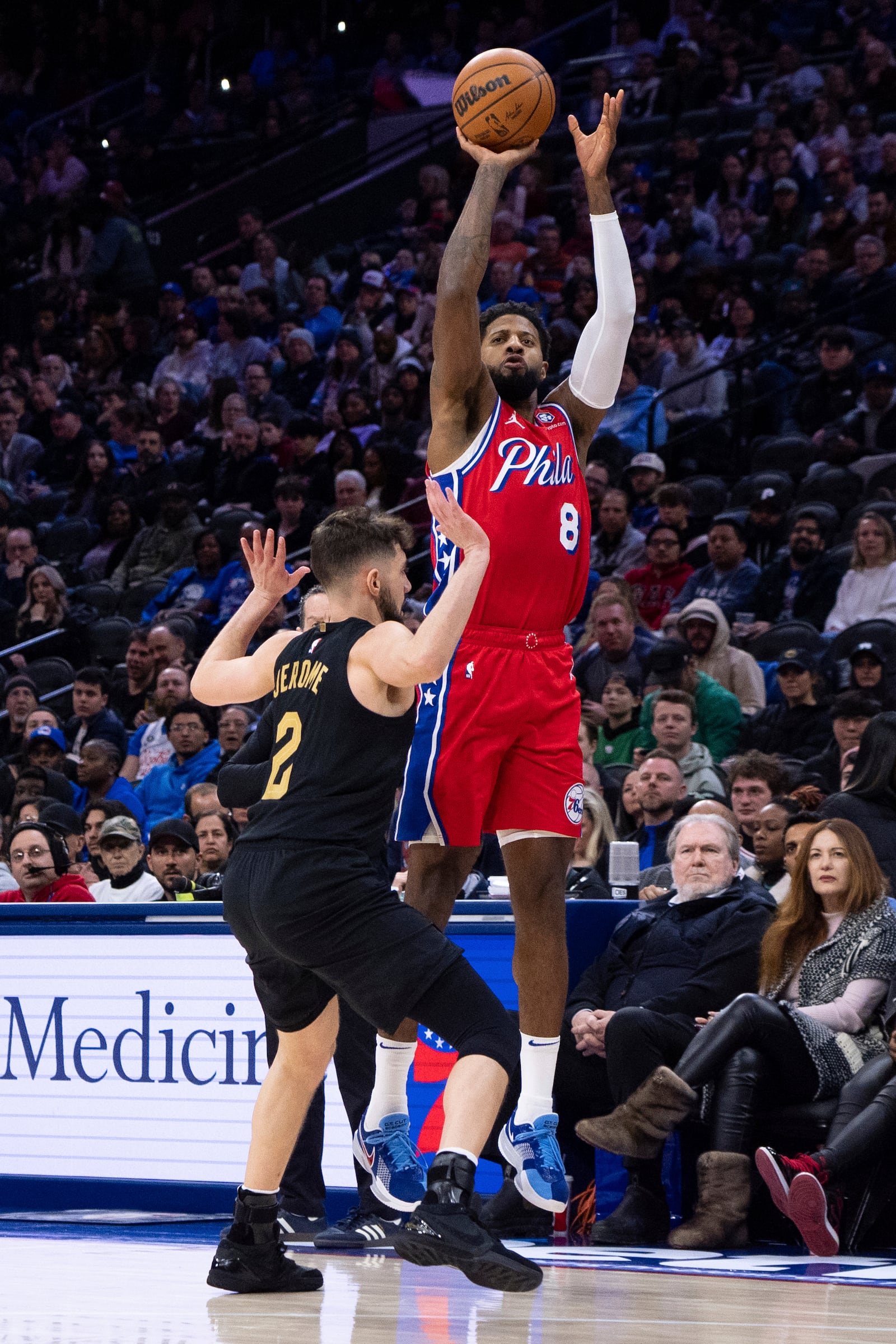 Philadelphia 76ers' Paul George (8) shoots a 3-point shot over Cleveland Cavaliers' Ty Jerome (2) during the first half of an NBA basketball game Friday, Jan. 24, 2025, in Philadelphia. (AP Photo/Chris Szagola)