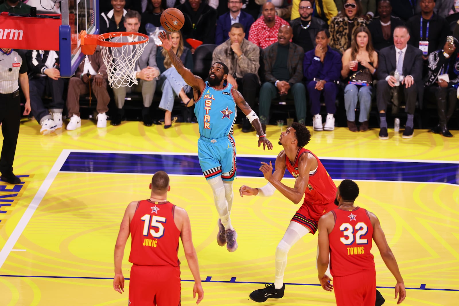 Dallas Mavericks guard Kyrie Irving scores past San Antonio Spurs center Victor Wembanyama during the NBA All-Star basketball game Sunday, Feb. 16, 2025, in San Francisco. (AP Photo/Jed Jacobsohn)