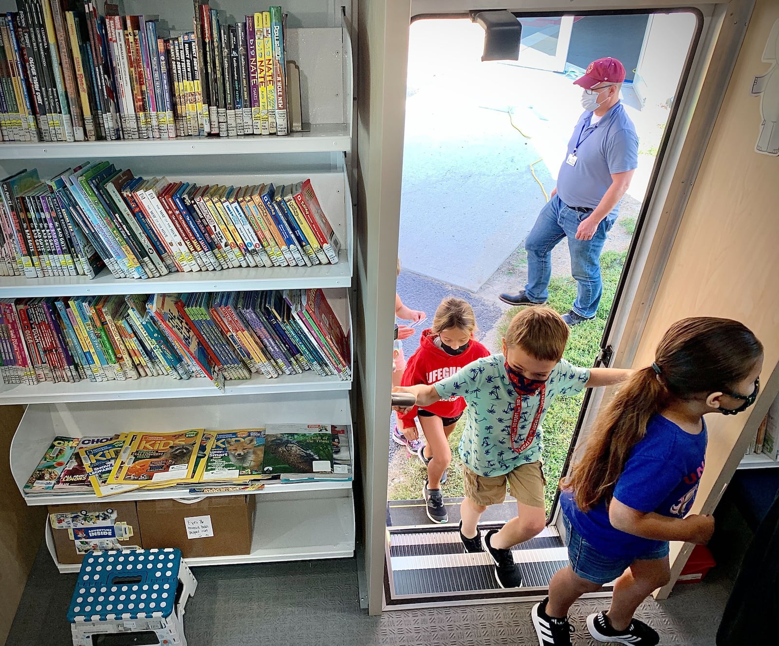 Students at Greeneview Elementary School in Jamestown enter the new Greene County Bookmobile, Tuesday, Sept. 14, 2021. Greeneview started the year with masks optional, then implemented a mask mandate when COVID cases surged, then went back to optional-but-recommended on Oct. 20. MARSHALL GORBY\STAFF