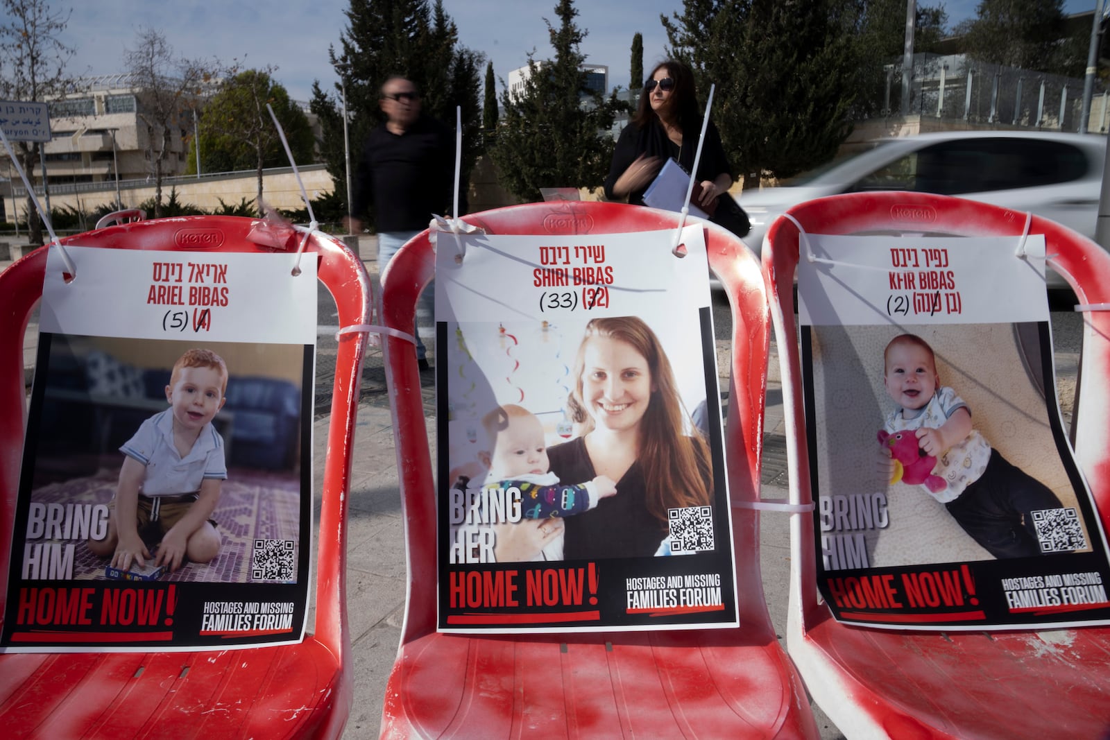 Posters of Shiri Bibas, center, and her sons Ariel, left, and Kfir, right, who were taken hostage by Hamas militants on Oct. 7, 2023, are displayed on empty chairs in Jerusalem, Wednesday, Feb. 19, 2025. (AP Photo/Maya Alleruzzo)