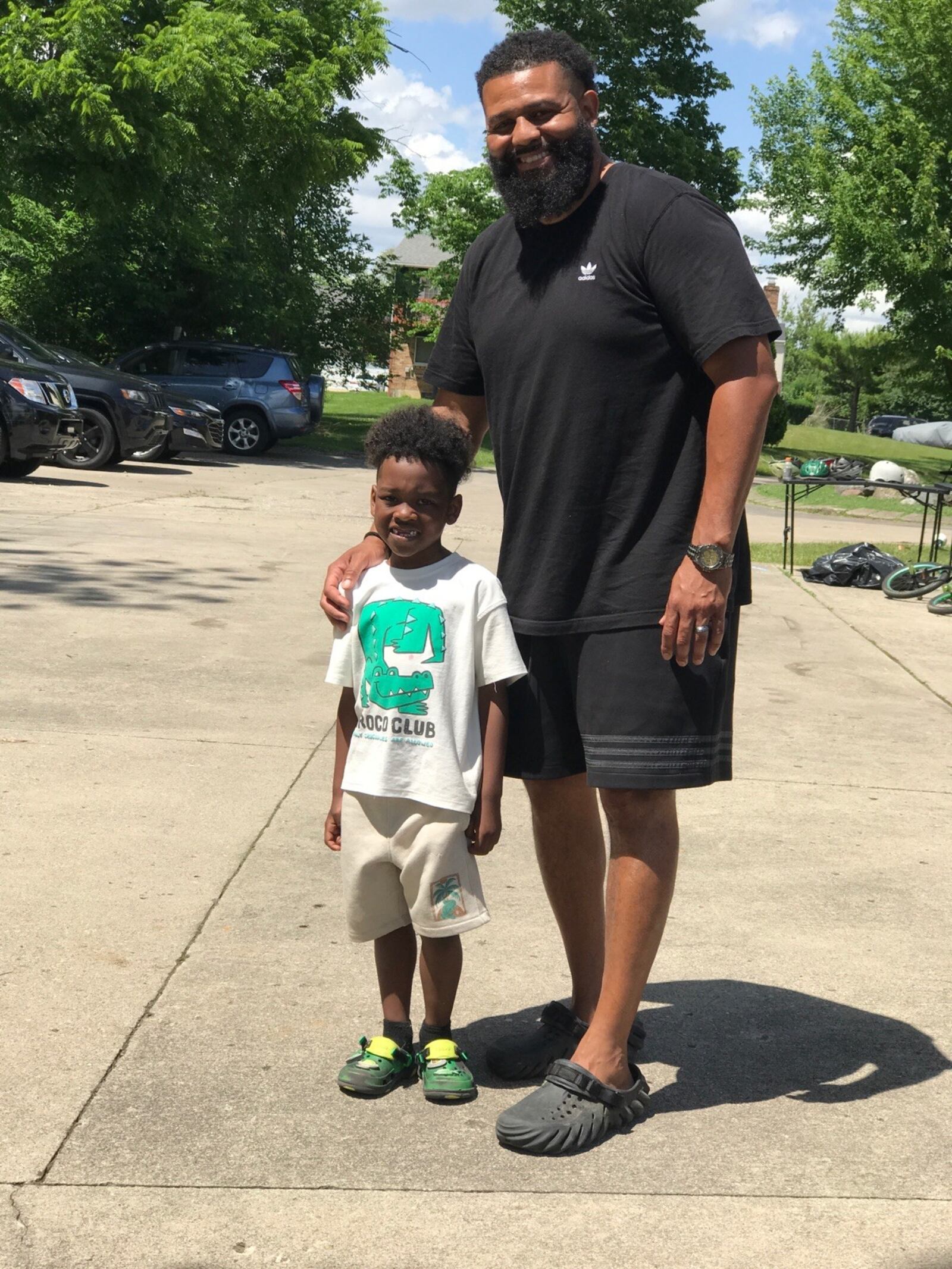 Anthony Parker, founder of the non-profit Extraordinary Men Mentoring Group and the head football and basketball coach at West Carrollton High, with one of the kids in his summer camp, 7-year-old Mason Kimble, a second grader at Richard Allen School and the star of Thursday afternoon’s talk session that ended the day. Tom Archdeacon/CONTRIBUTED