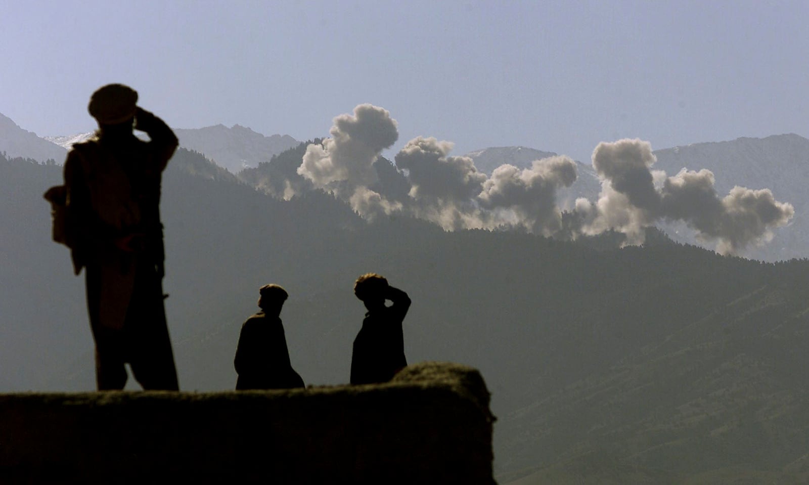 FILE  Eastern Shura fighters watch as U.S. B-52s carpet bomb an area of the Tora Bora mountains in Afghanistan, Dec. 9, 2001. B-52s were scheduled for retirement years ago, but they are expected to keep flying until at least 2040. (Stephen Crowley/The New York Times)