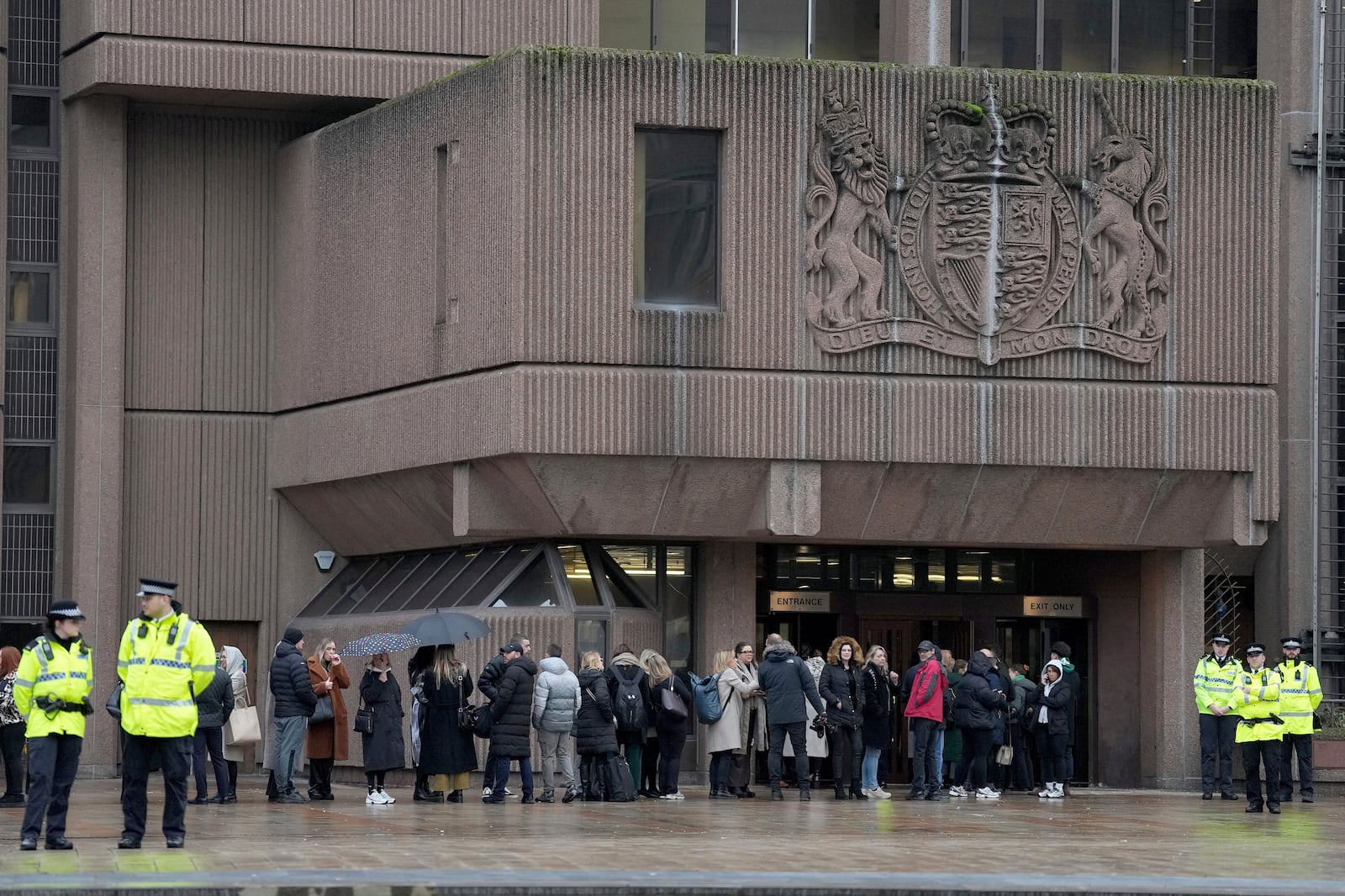 People queue at Liverpool Crown Court in Liverpool, England, Monday, Jan. 20, 2025 where Axel Rudakubana is charged with killing three girls and wounding 10 other people in a stabbing rampage at a Taylor Swift-themed dance class in England last summer.(AP Photo/Jon Super)