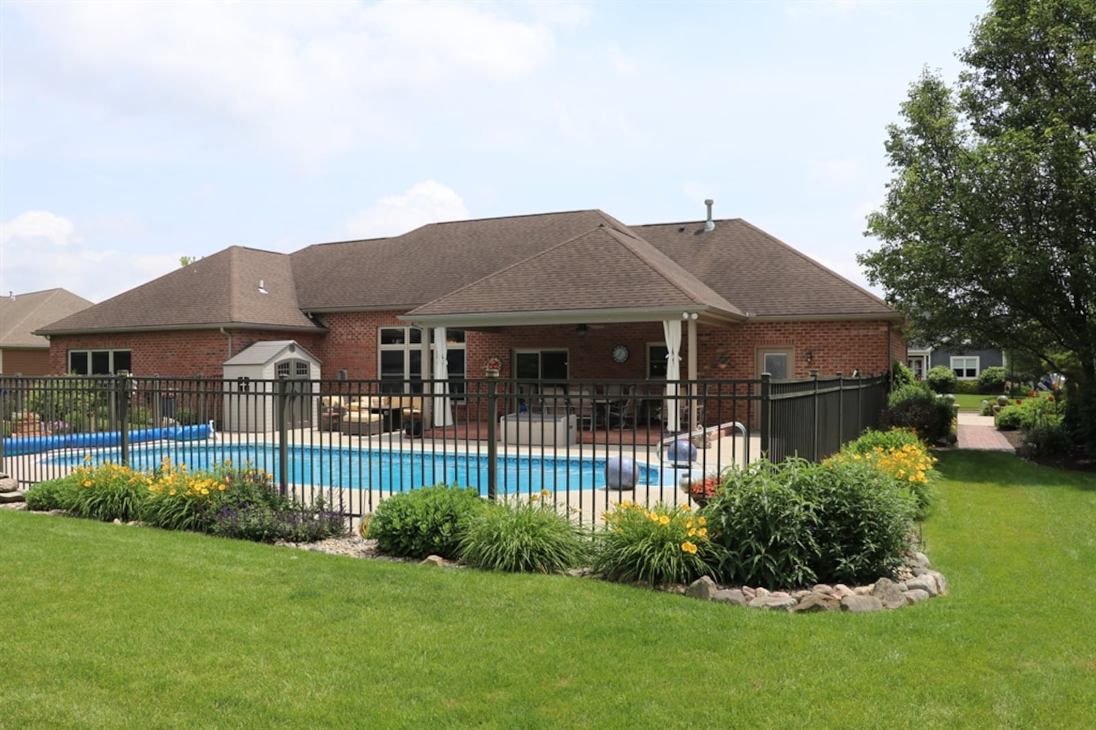 Rock-trimmed gardens surround the in-ground swimming pool.