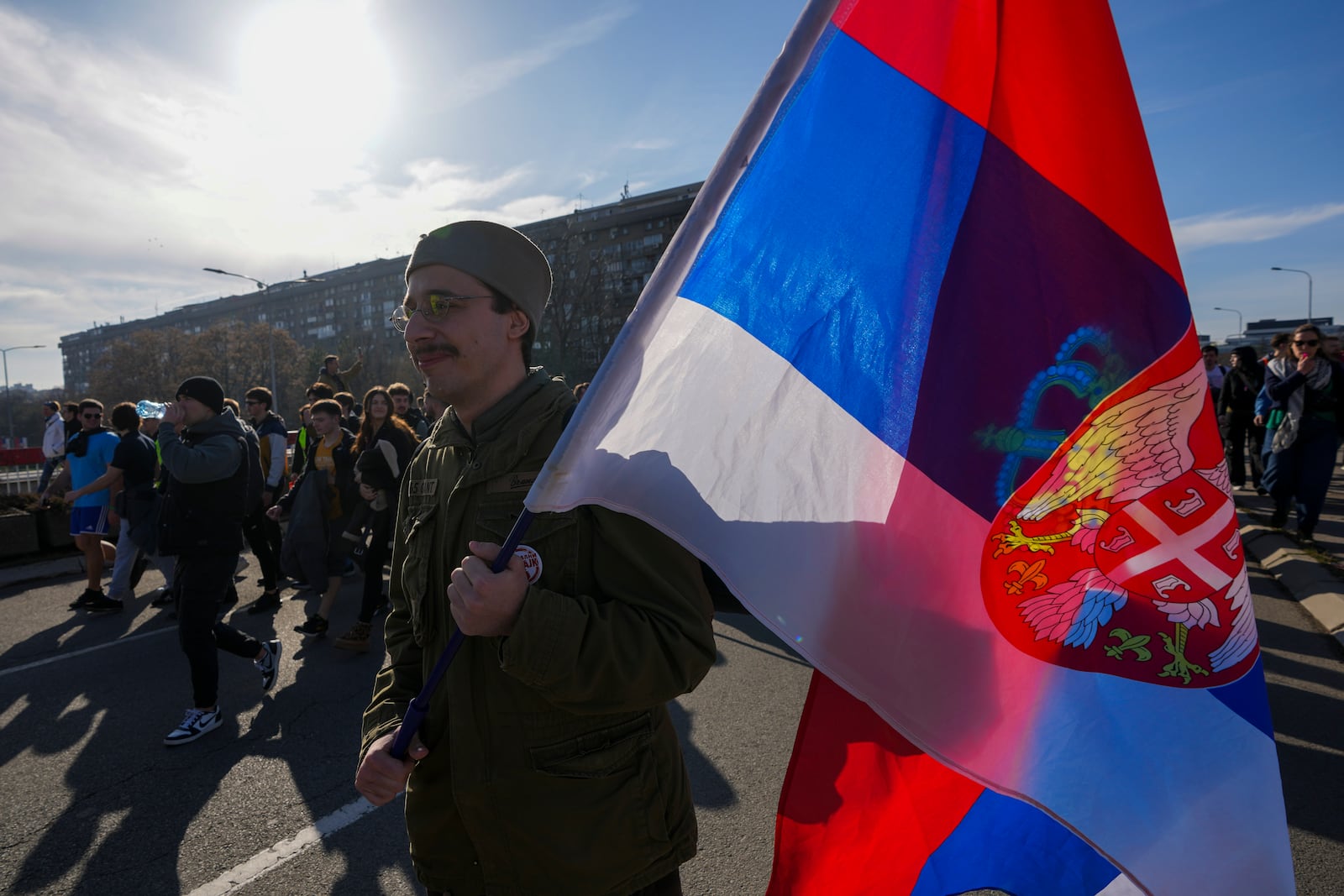 Students walk on the street towards the northern city of Novi Sad, where they will participate in a 24 hour block of three bridges to protest the deaths of 15 people killed in the November collapse of a train station canopy, in Belgrade, Serbia, Thursday, Jan. 30, 2025. (AP Photo/Darko Vojinovic)