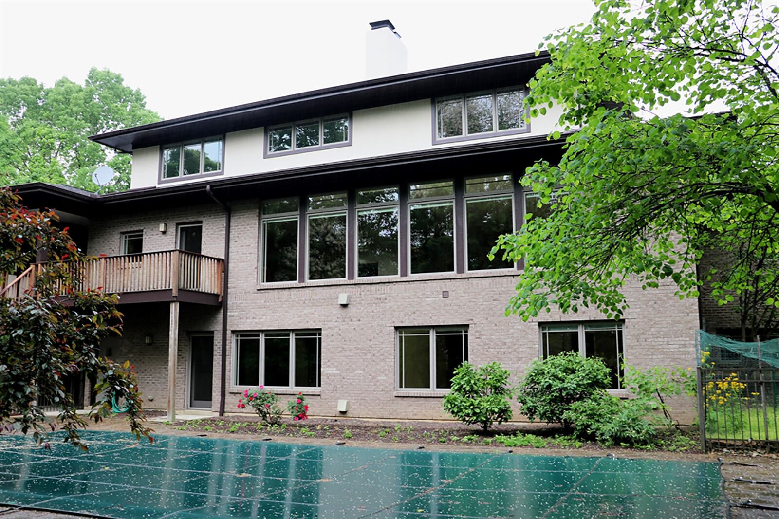 Mature trees line one side of the property and surround the backyard oasis, including the heated, in-ground swimming pool, paver-brick sun deck and covered patio. CONTRIBUTED PHOTO BY KATHY TYLER