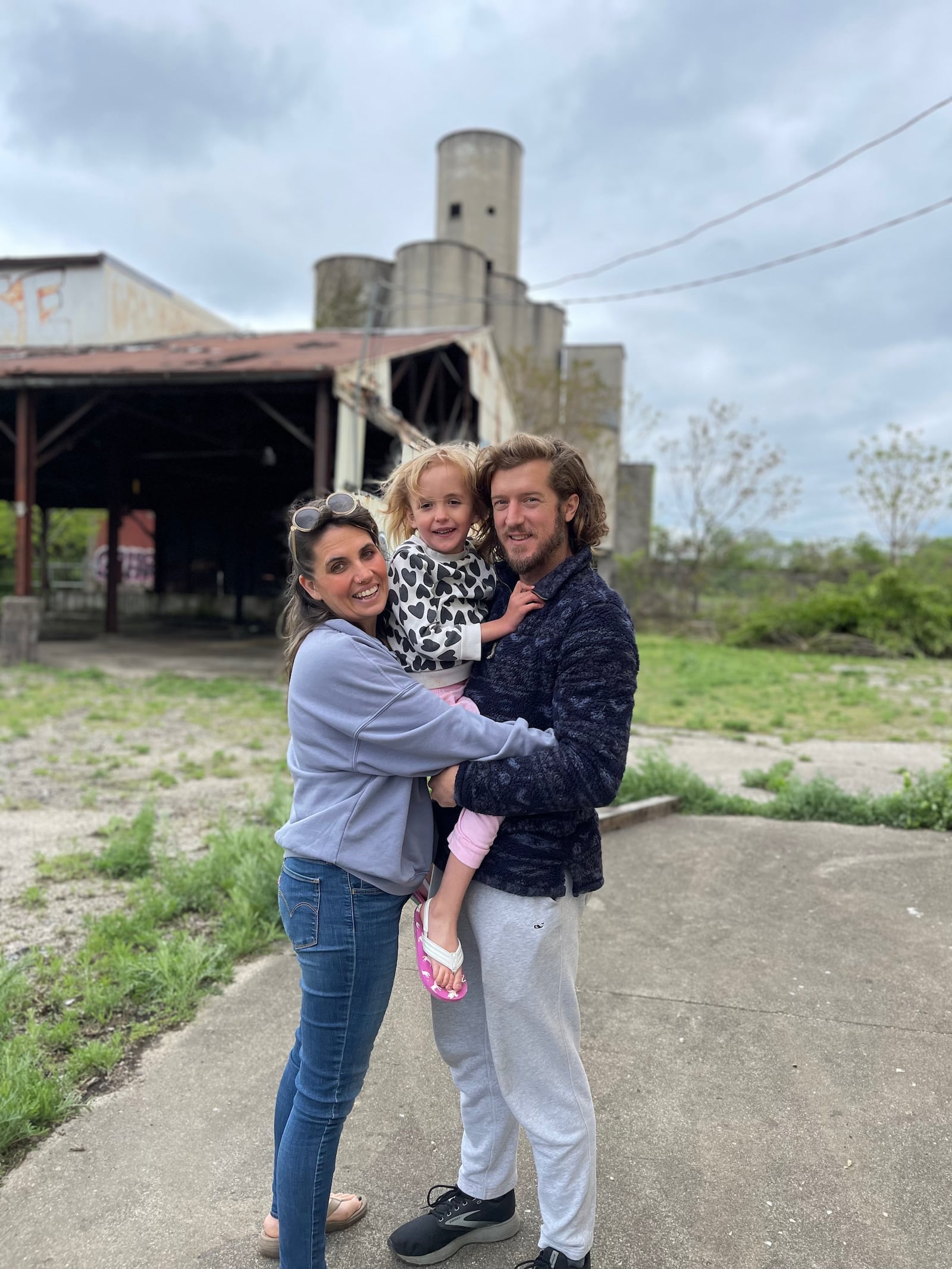 Wes, Kathleen and Eleanor Hartshorn stand in front of the Silos in downtown Dayton.