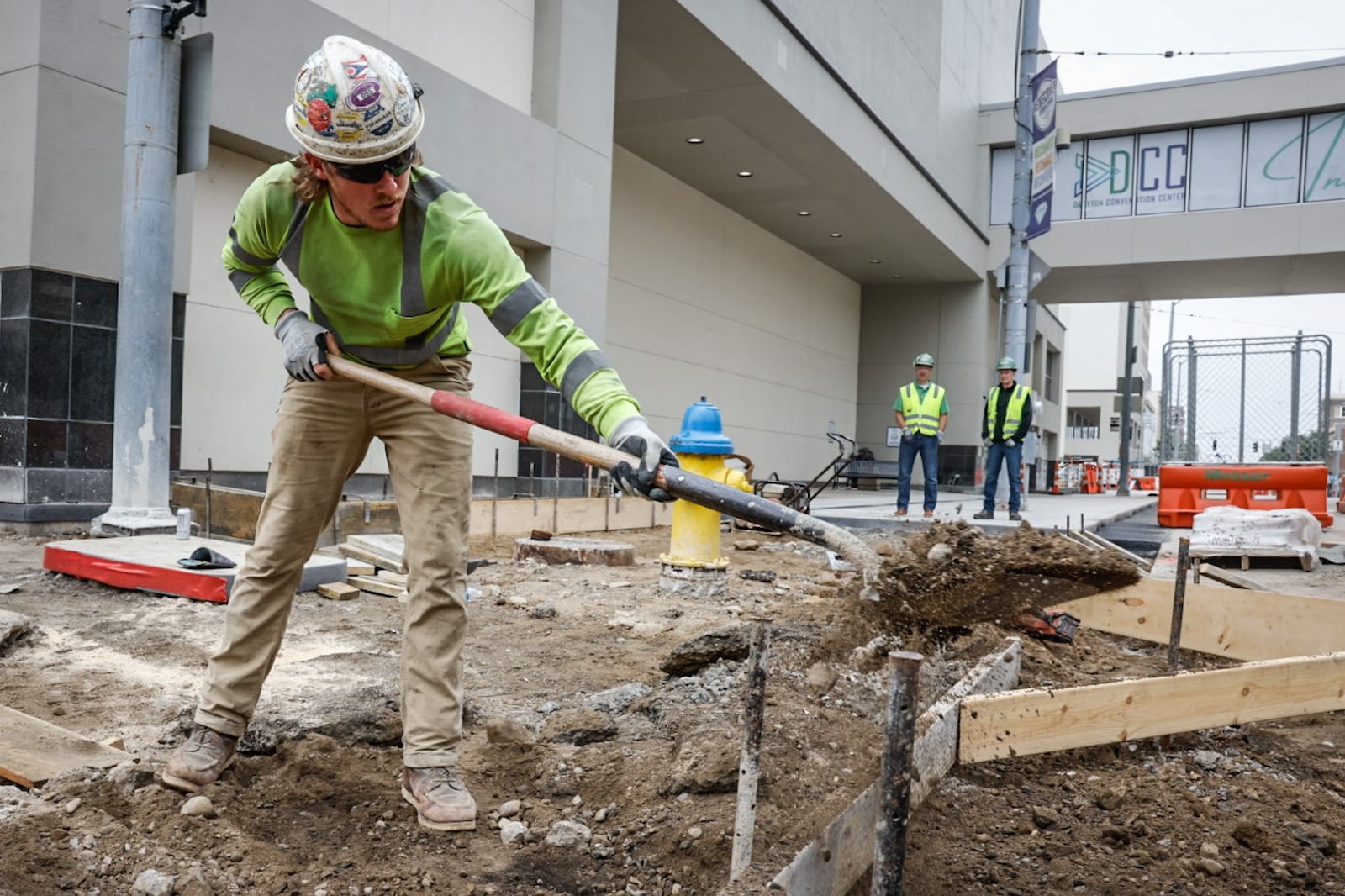 Construction foreman Bradley Garber levels-off sidewalks around the Dayton Convention Center on 5th Street for new concrete. JIM NOELKER/STAFF