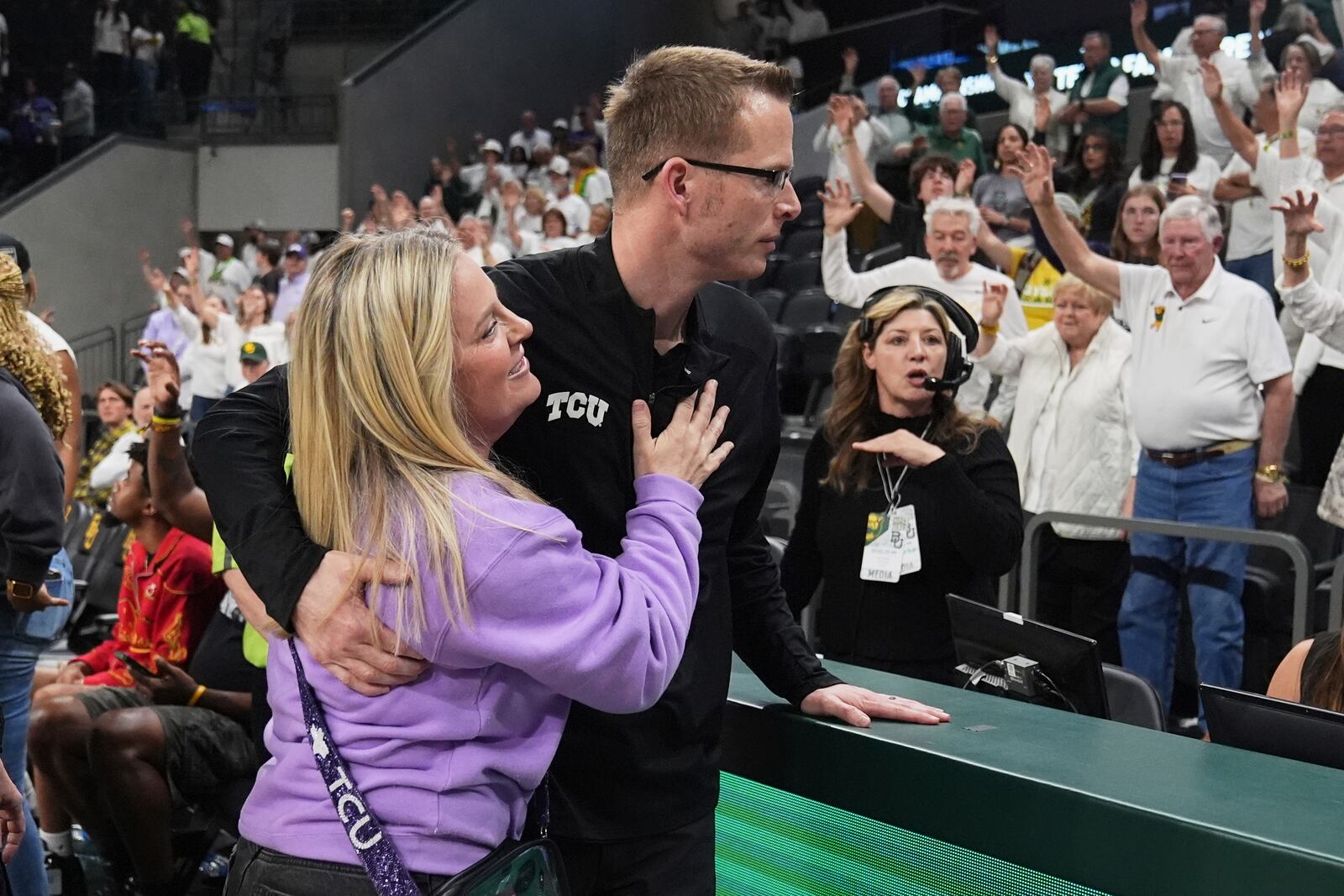 TCU head basketball coach Mark Campbell hugs his wife Ashley, left, after his team's win against Baylor in an NCAA college basketball game in Waco, Texas, Sunday, March 2, 2025. (AP Photo/Tony Gutierrez)