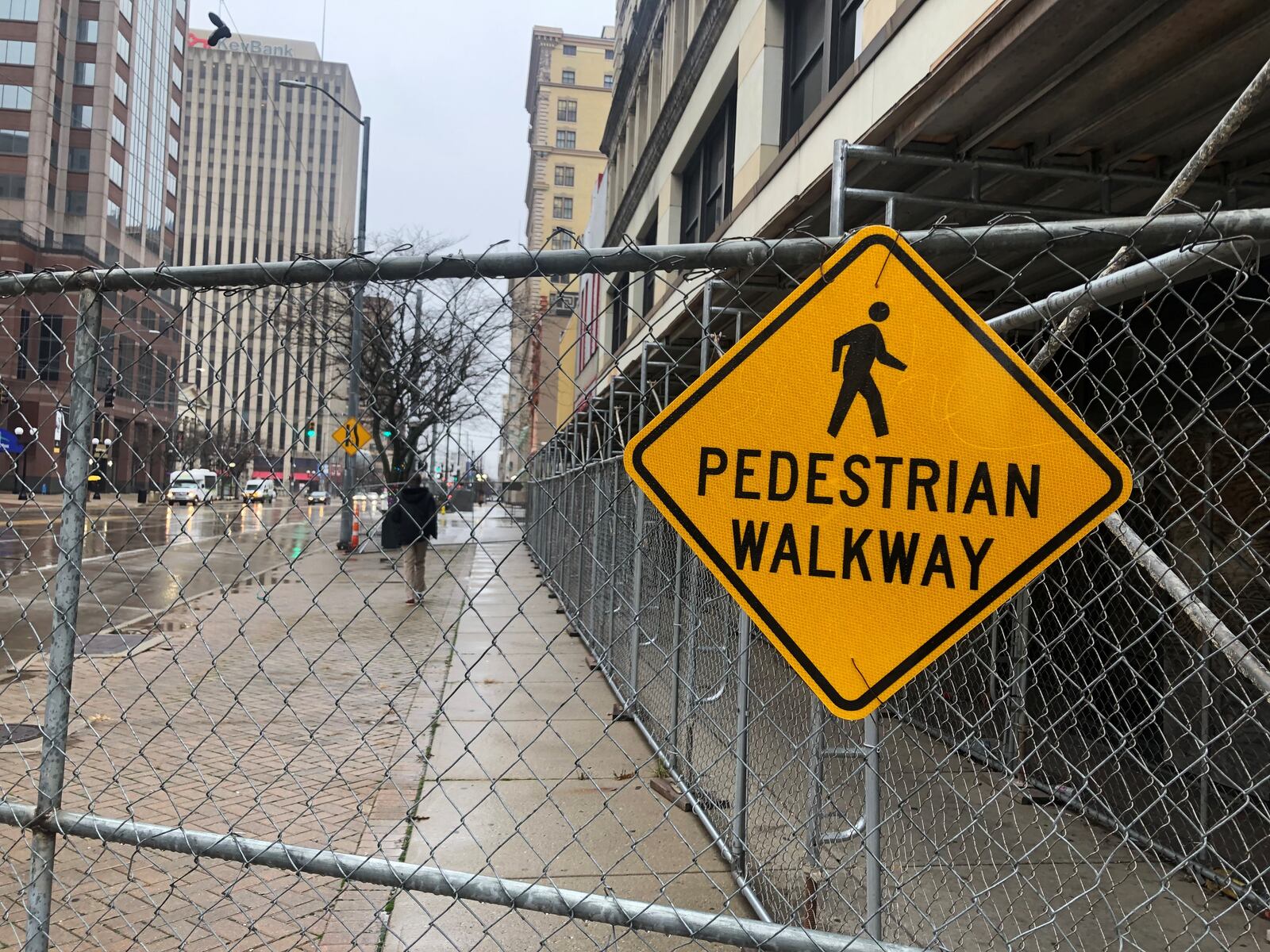 The scaffolding and covered pedestrian walkway along the South Main Street side of the Centre City building in downtown Dayton. CORNELIUS FROLIK / STAFF