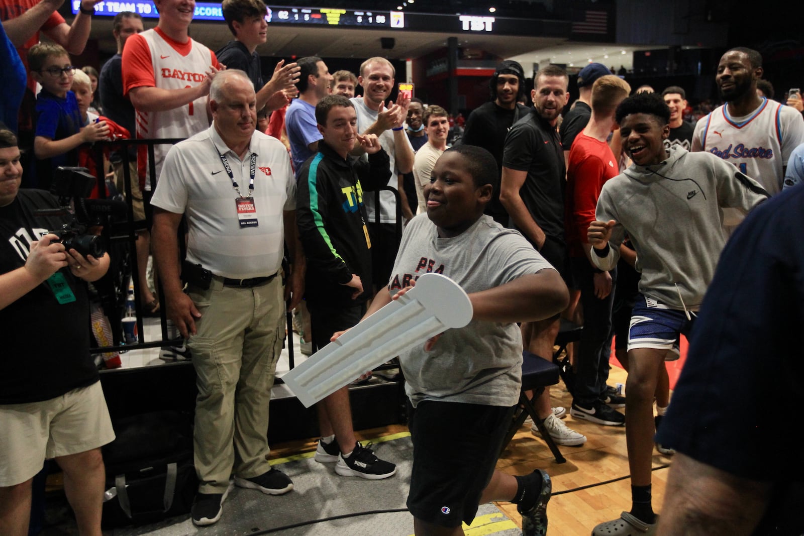 Scoochie Smith's cousin, Bam Dawson, takes the placard and moves the Red Scare name ahead in the bracket after a victory against the Golden Eagles in The Basketball Tournament on Wednesday, July 27, 2022, at UD Arena. David Jablonski/Staff