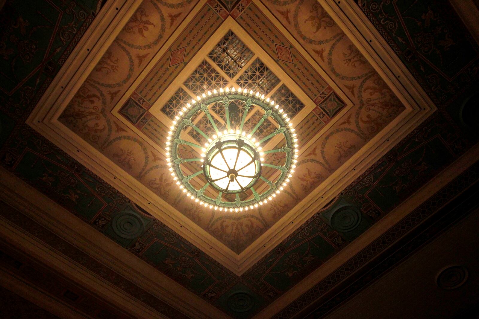 An enormous chandelier hangs from the ornately painted ceiling in the Schiewetz Auditorium within the Dayton Masonic Center. LISA POWELL / STAFF