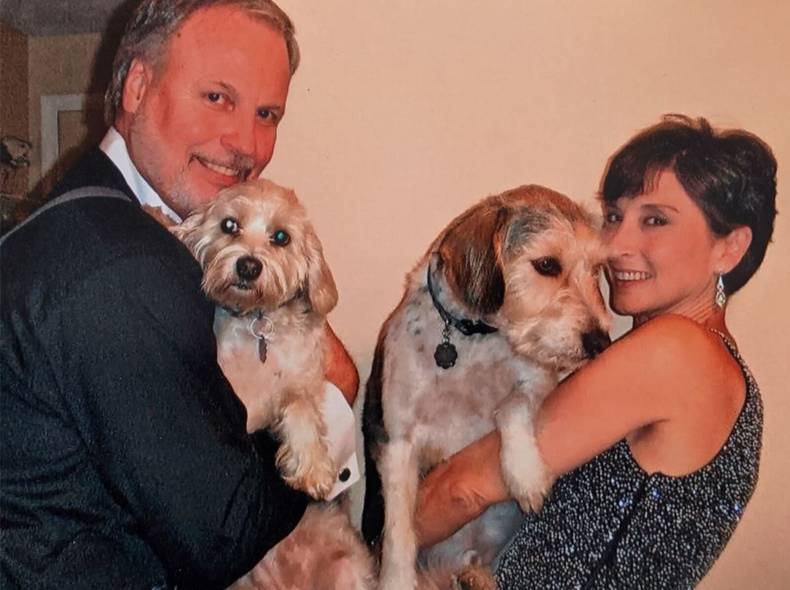 Dayton Ballet Artistic Director Karen Russo Burke loves dogs and continues to host “Muttcracker” where animals are available for fostering or adoption. Pictured: Burke holding Benni and Dermot Burke (left) holding Callie. CONTRIBUTED