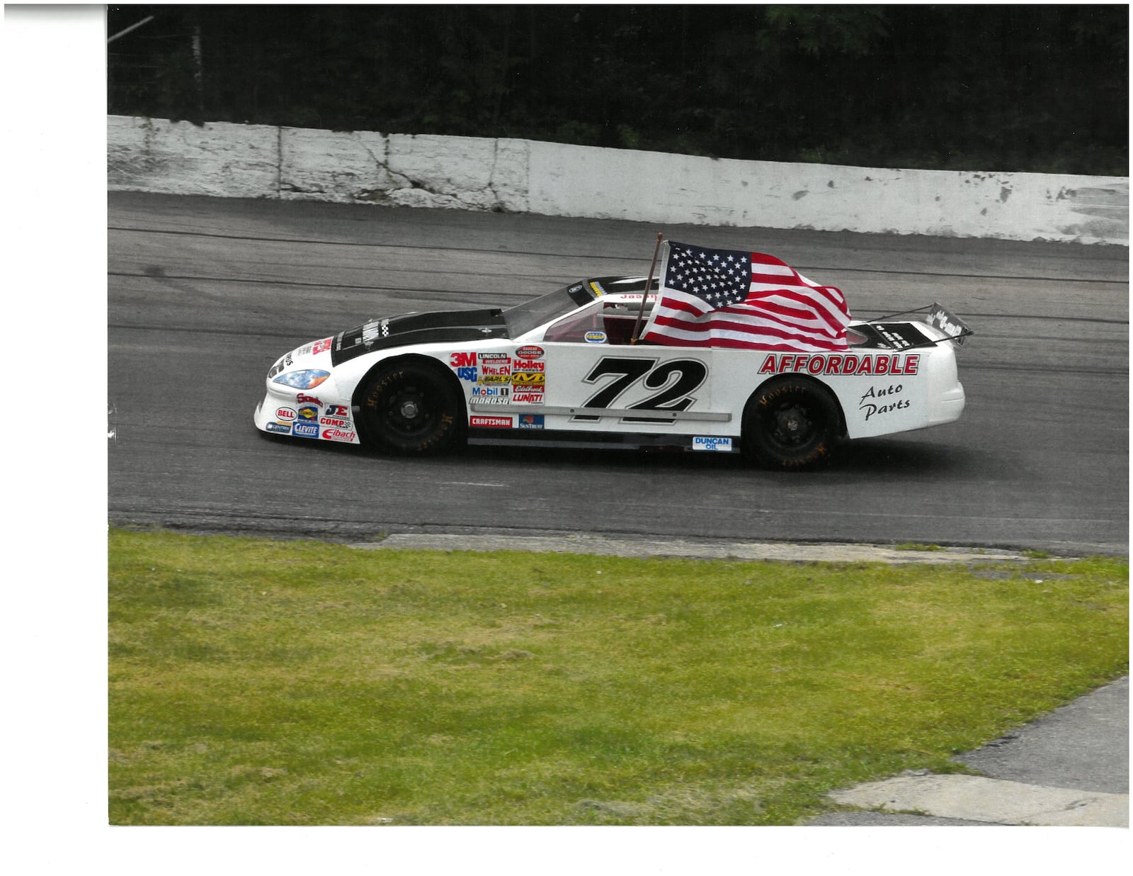 Lil Bobby Korn at the wheel of his grandpa’s No. 72 race car as he takes the American flag around the Shady Bowl track before the start of the Bob Korn Memorial race there. CONTRIBUTED