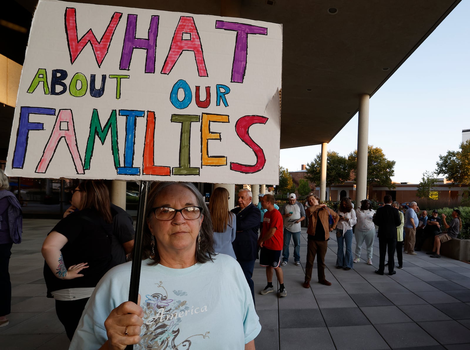 Lisa "H" holds up a sign outside the Springfield City Commission Meeting Tuesday, Sept. 10, 2024. BILL LACKEY/STAFF