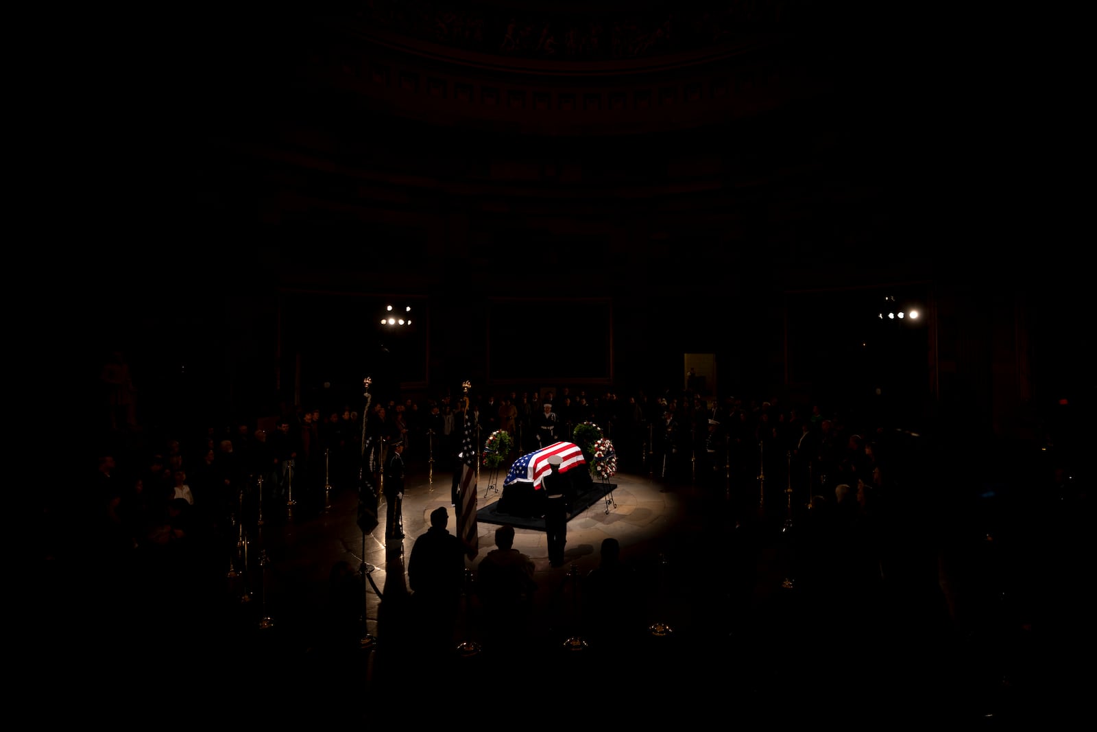 Members of the public view the flag-draped casket of former President Jimmy Carter as it lies in state in the Rotunda, at the Capitol in Washington, Tuesday, Jan. 7, 2025. (AP Photo/Ben Curtis)