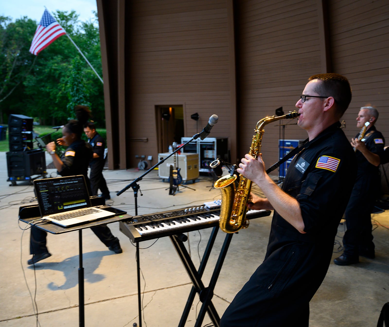 Tech. Sgt. Greg Pflugh plays the saxophone during a performance by Flight One, an Air Force rock band, on Aug. 13 at Centerville Community Amphitheater in Stubbs Park. In the course of the show, Pflugh played the sax, keyboard and guitar. He is also the band’s music director. U.S. AIR FORCE PHOTO/R.J. ORIEZ