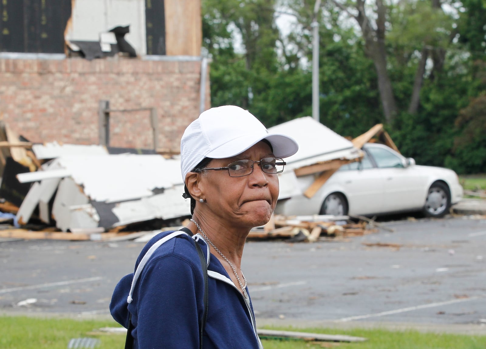 Part of wall landed on April Cartwright's car at the Woodland Hills Apartments in Trotwood during the devastating Memorial Day tornado, which also left her without a home. Federal officials examined the damage there Wednesday. CHRIS STEWART / STAFF