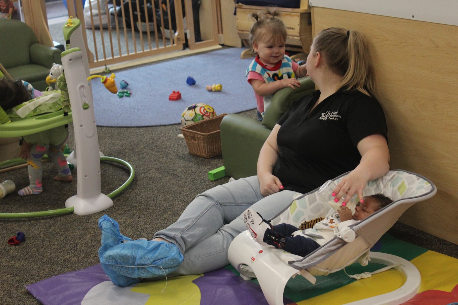 A worker tends to children at United Rehabilitation Services.