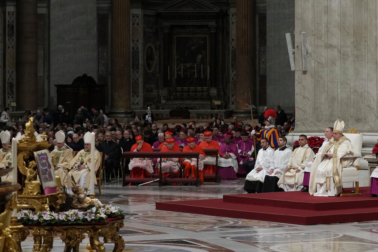 Pope Francis presides over the Christmas Eve Mass in St. Peter's Basilica at The Vatican, Tuesday, Dec. 24, 2024, after opening the basilica's holy door marking the start of the Catholic jubilar year 2025. (AP Photo/Andrew Medichini)