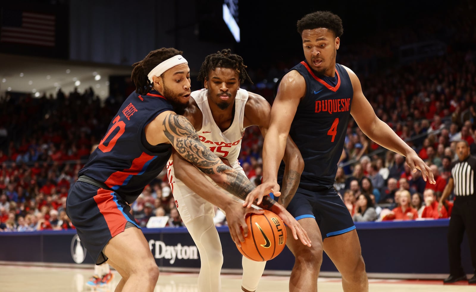 Dayton's DaRon Holmes II chases a loose ball against Duquesne on Wednesday, Dec. 28, 2022, at UD Arena. David Jablonski/Staff