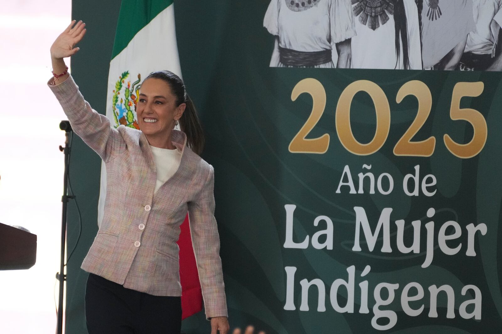 President Claudia Sheinbaum waves as she arrives for a Housing for Wellbeing event, a government-funded home improvement program, in Mexico City, Saturday, Feb. 1, 2025. (AP Photo/Marco Ugarte)