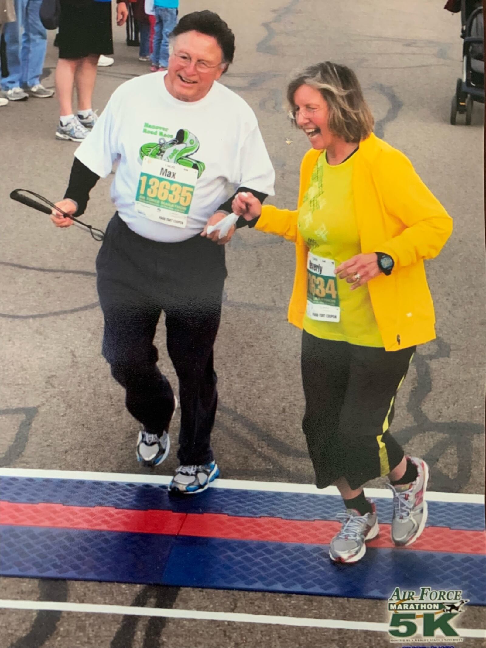 Max Bassett crosses the finish line of the 2012 Air Force Marathon 5K with his wife Bev, his visual guide. CONTRIBUTED