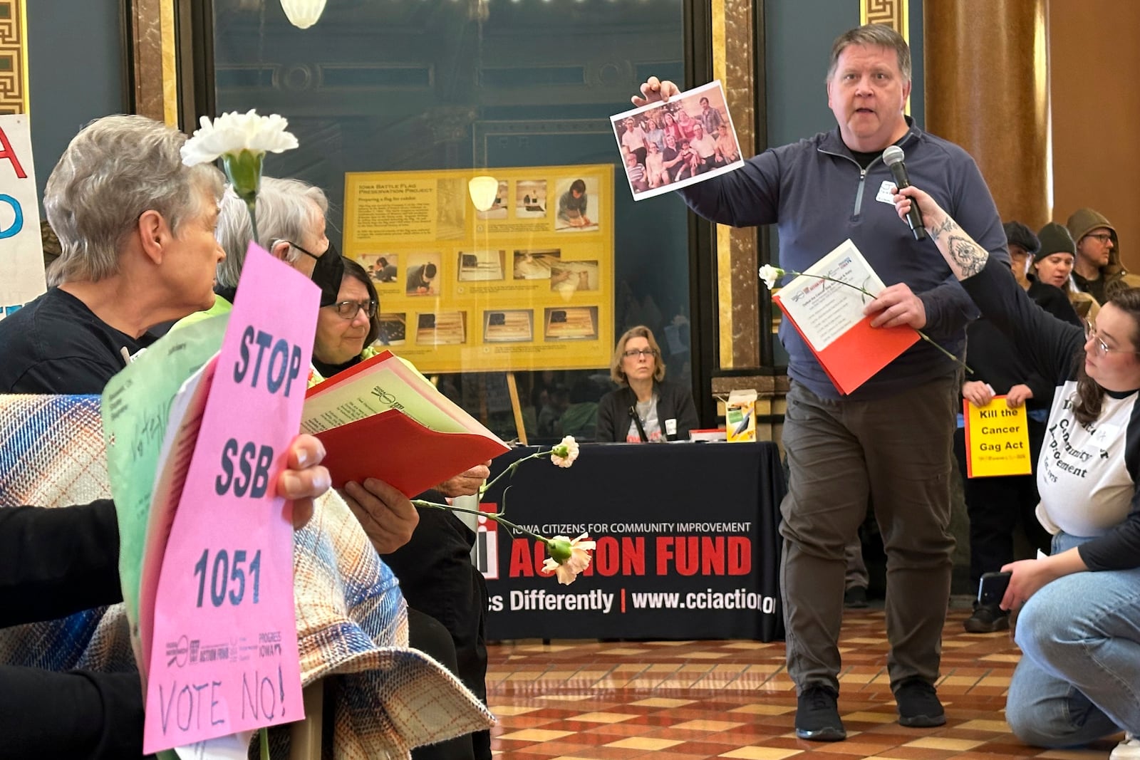 John Crabtree tells a crowd of protesters about cancer's impact on his family as part of a Feb. 10, 2025, vigil in Des Moines, Iowa, to oppose a bill that would protect pesticide companies from lawsuits that claim its popular weedkiller causes cancer. (AP Photo/Hannah Fingerhut)