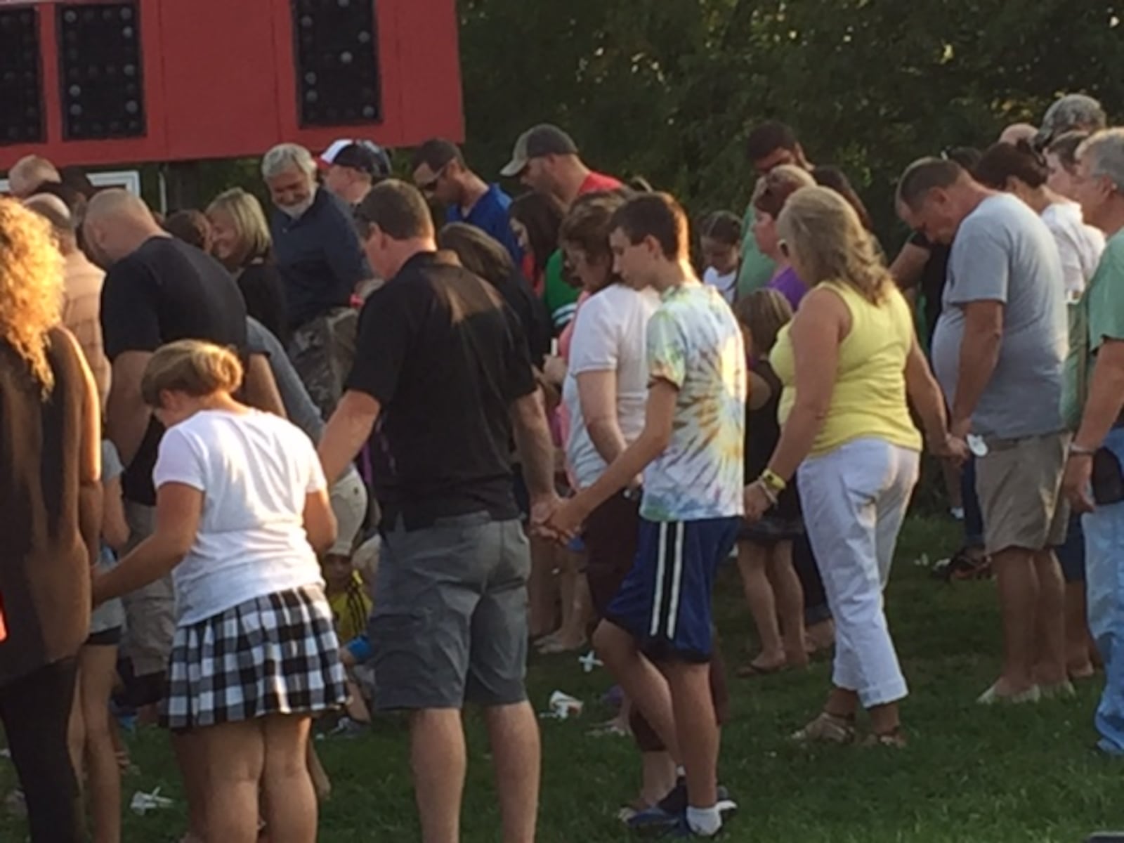 Community members gather at Camden Primary School's football field Sunday for a candlelight vigil honoring a family of three killed in a Tuesday crash on Ohio 127 at Ohio 725. Sean Cudahy/Staff